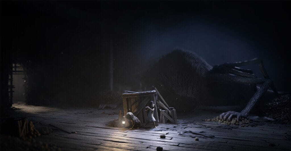 Personagens de Reanimal escondidos atrás de uma caixa, em um jogo multiplayer de terror cooperativo.